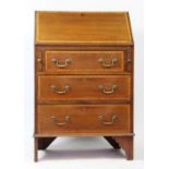 An Edwardian mahogany and satinwood banded bureau, with fall over three graduated long drawers,
