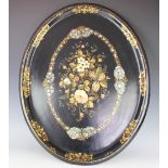A Victorian lacquered papier mache oval tray, painted and inlaid with mother of pearl flowers,