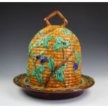 A majolica cheese bell and base, modelled as a bee hive with fruiting vines,