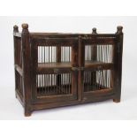 A 17th century style stained wood food hutch, with two doors and wrought iron bar sides,