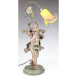 An Art Nouveau style bronzed table lamp, modelled as a cherub, with mottled glass shade,