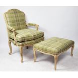 A Louis XV style carved beech fauteuil and matching stool, the chair with open arms,
