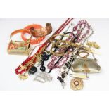 A selection of costume jewellery and objects, including a plated purse, a yellow metal brooch,