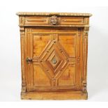 An 18th century continental style carved pine cupboard, with frieze drawer above a panelled door,