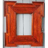 A pair of Edwardian Arts and Crafts oak picture frames, with carved geometric frames,