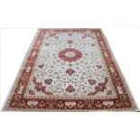 A Kashmir bamboo silk rug, worked with an overall floral design against a white ground,