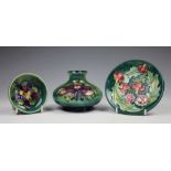 Three pieces of Moorcroft comprising; an Aquilegia pattern posy vase, 8cm high,