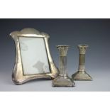 A pair of silver candlesticks,