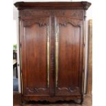 An 18th century French carved oak armoire of large proportions,