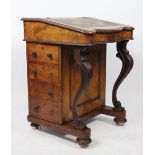 A Victorian walnut serpentine Davenport, with four side drawers, on bun feet,