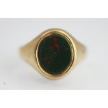 A gents bloodstone set signet ring, of oval form, all set in 9ct yellow gold, weight 6.