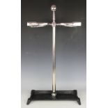An equestrian stick stand, designed as a central riding crop with two stirrup stick holders, 71.