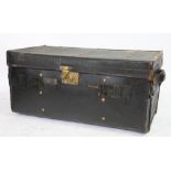 A late 19th century leather and iron bound canvas travelling trunk,