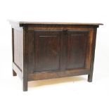 A 1920's oak coffer, of small proportions, with hinged lid and panelled front,