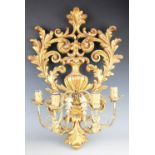 A pair of Louis XV style carved gilt wood wall lights,