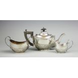 An associated three piece silver bachelors tea set, Martin Hall & Co & Ltd, comprising; a teapot,