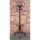 An early 20th century bentwood half hat stand, with four hook above an umbrella division,