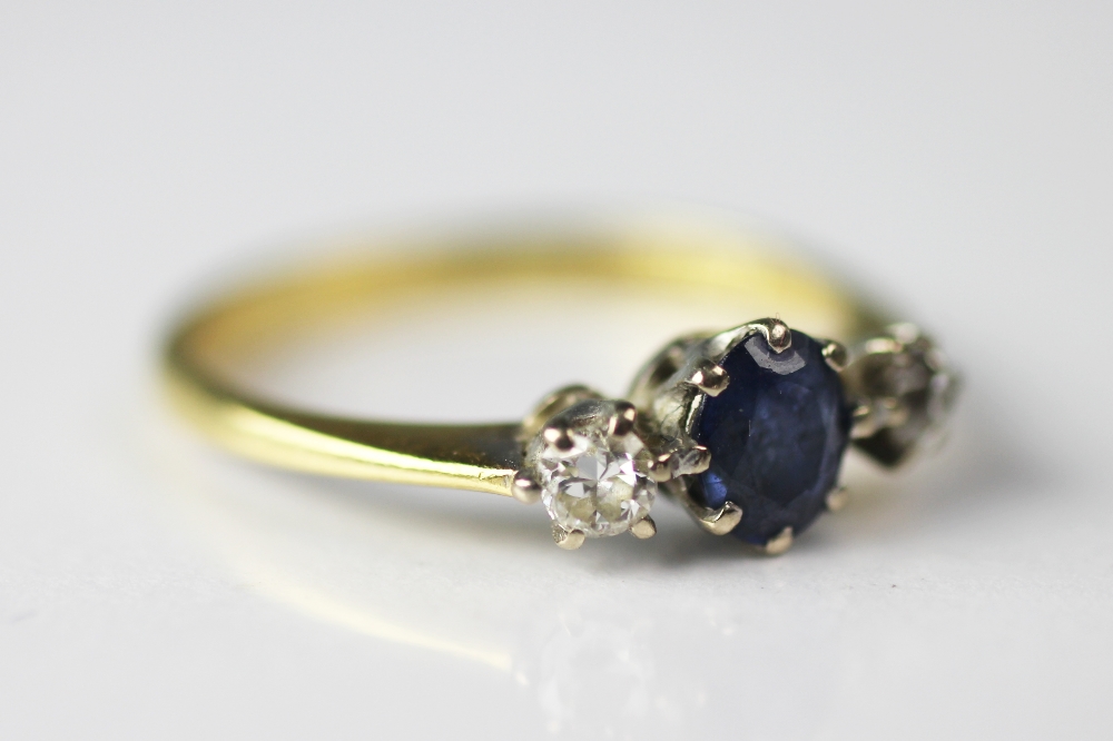A diamond and sapphire three stone ring, set in 18ct yellow and white gold,