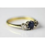 A diamond and sapphire three stone ring, set in 18ct yellow and white gold,