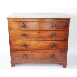 A George III mahogany chest, of two short and three long drawers, with turned wood handles,