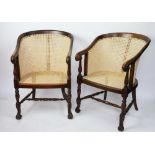 A pair of early 20th century carved walnut tub chairs,