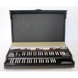 A Vox Continental 300 electric organ, in hardwood travelling case,