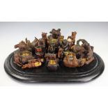 A collection of seventeen 19th century and later Black Forest carved wood bears,