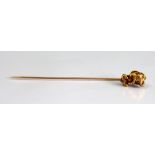 A gold 'nugget' set stick pin,