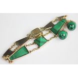 A malachite set bracelet, designed as seven malachite set panels, of tapering and square shape,