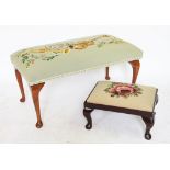 A lounge stool, the tapestry top worked with musical instruments, on cabriole legs, 78cm wide,