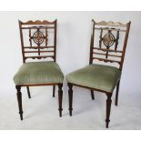 A set of four late Victorian inlaid rosewood dining chairs, with upholstered seats,