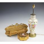 A French gilt metal casket, cast with garland swags and flowering scroll foliage, red silk interior,