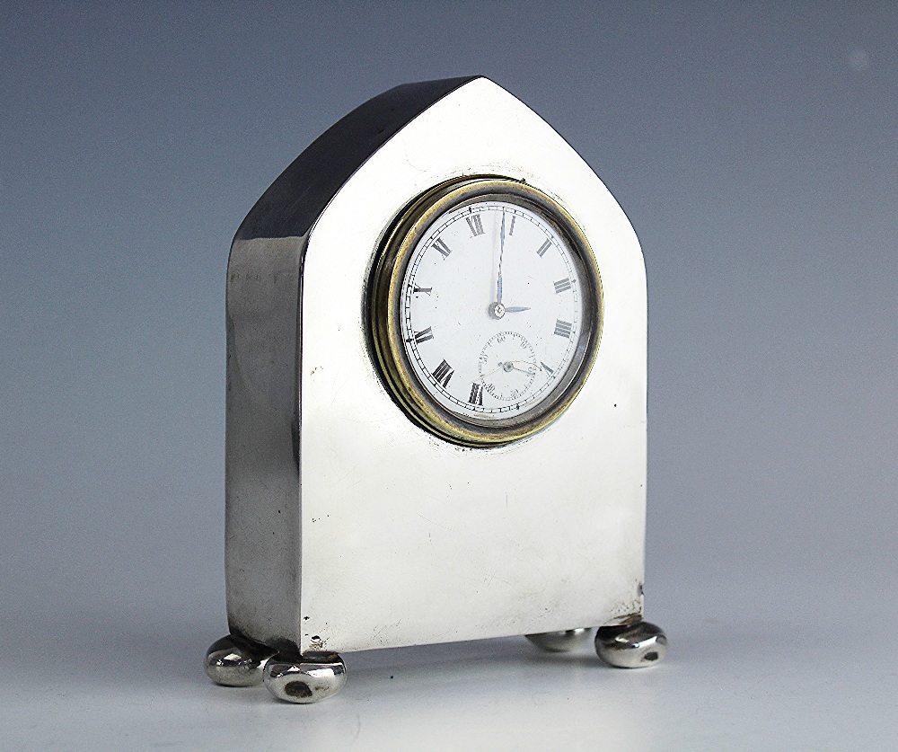 A George V silver cased lancet shaped bedside timepiece, Charles S Green & Co Ltd, Birmingham 1919,