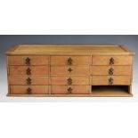 An Edwardian pine collectors bank of drawers, with 11 (ex 12) drawers, 27cm H x 77cm W x 30.