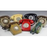 A collection of five GPO 746 model dial telephones, including one in red,