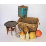 A selection of vintage items to include a large wicker basket, a vintage advertising can,