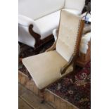 A Victorian walnut salon chair,