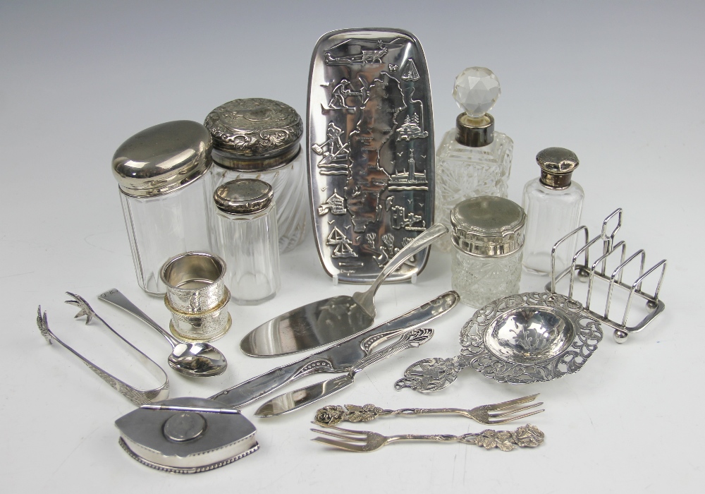 A collection of silver and white metal wares, to include; a Dutch silver straining spoon,