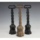 Three Regency style cast iron door porters, with lions paw bases,