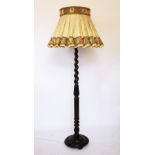 A 1920's carved oak standard lamp, with barley twist column, on circular base,