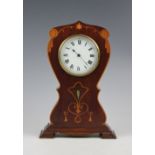 An Edwardian Art Nouveau inlaid mahogany mantel time piece, decorated with flowers,