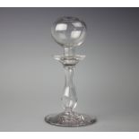 A 19th Century lace makers lamp with a wide circular spread foot rising to a hollow blown baluster