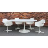 An Arkana oval dining table and six chairs in the manner of Eero Saarinen,