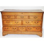 A George III oak mule chest, with hinged top over three dummy and five real drawers,