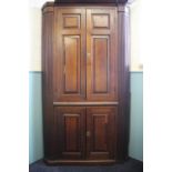 A George III curved back oak corner cabinet, two panelled doors enclosing serpentine shelves,