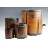Four graduated grain measures, each oak measure iron bound, largest with two wrought handles,