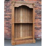 A modern pine open bookcase, with four adjustable shelves, pilaster side columns, on plinth base,