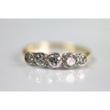 A five stone diamond ring, the five graduated diamonds each collet set in white metal,