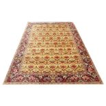 A Persian wool carpet, worked with an all over floral design against a green ground,