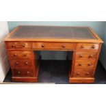 A Victorian walnut pedestal desk, with leather inset top, above an arrangement of nine drawers,